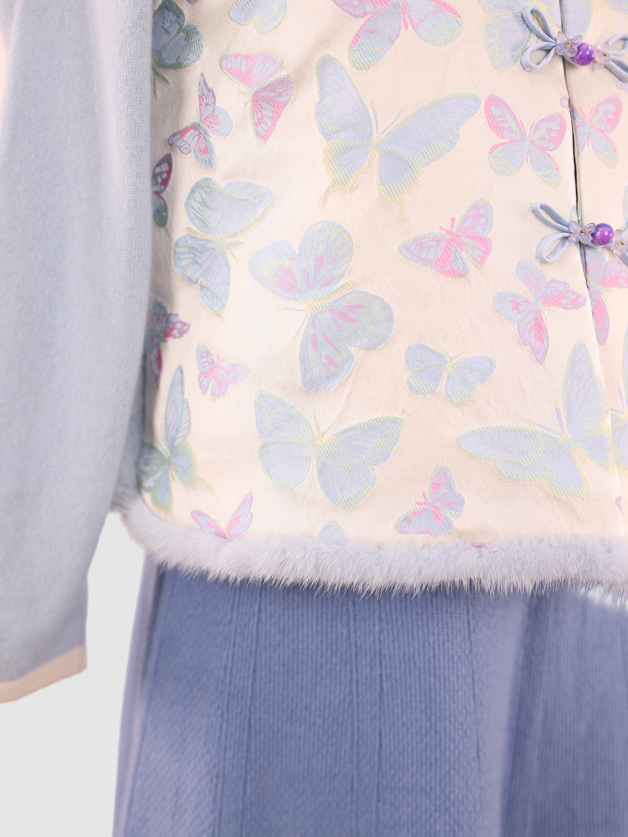 A close-up of the vest’s lower section showing the mink hem.