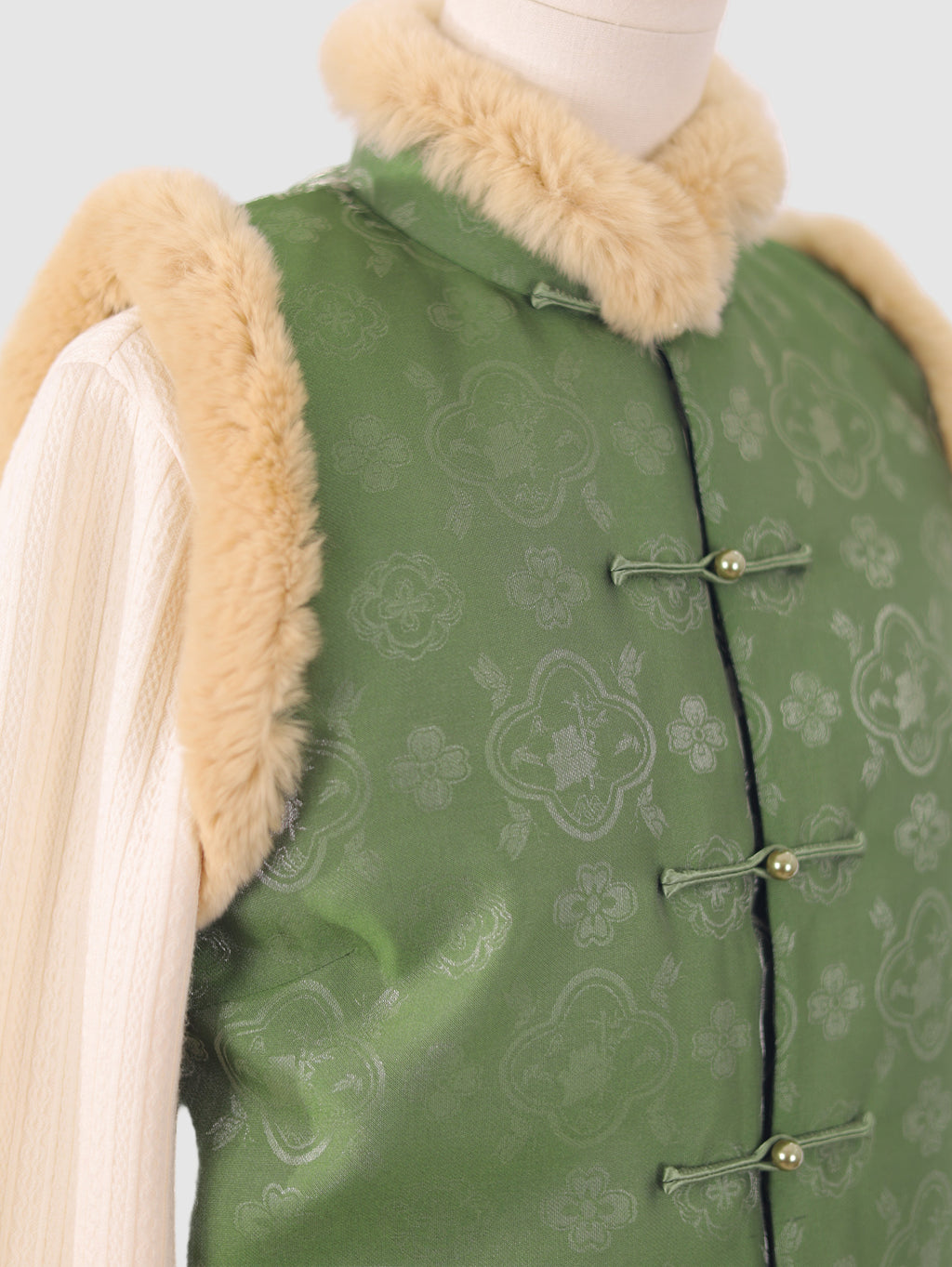 Close-up of the upper part of the vest showing jacquard texture and fur collar
