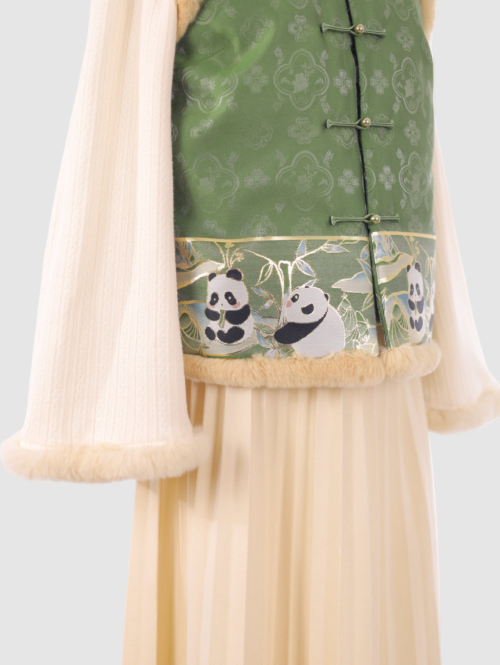 Detail shot of the panda embroidery and fur trim at the bottom of the vest
