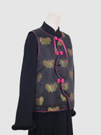 Side view of black butterfly jacquard vest with pink contrast piping