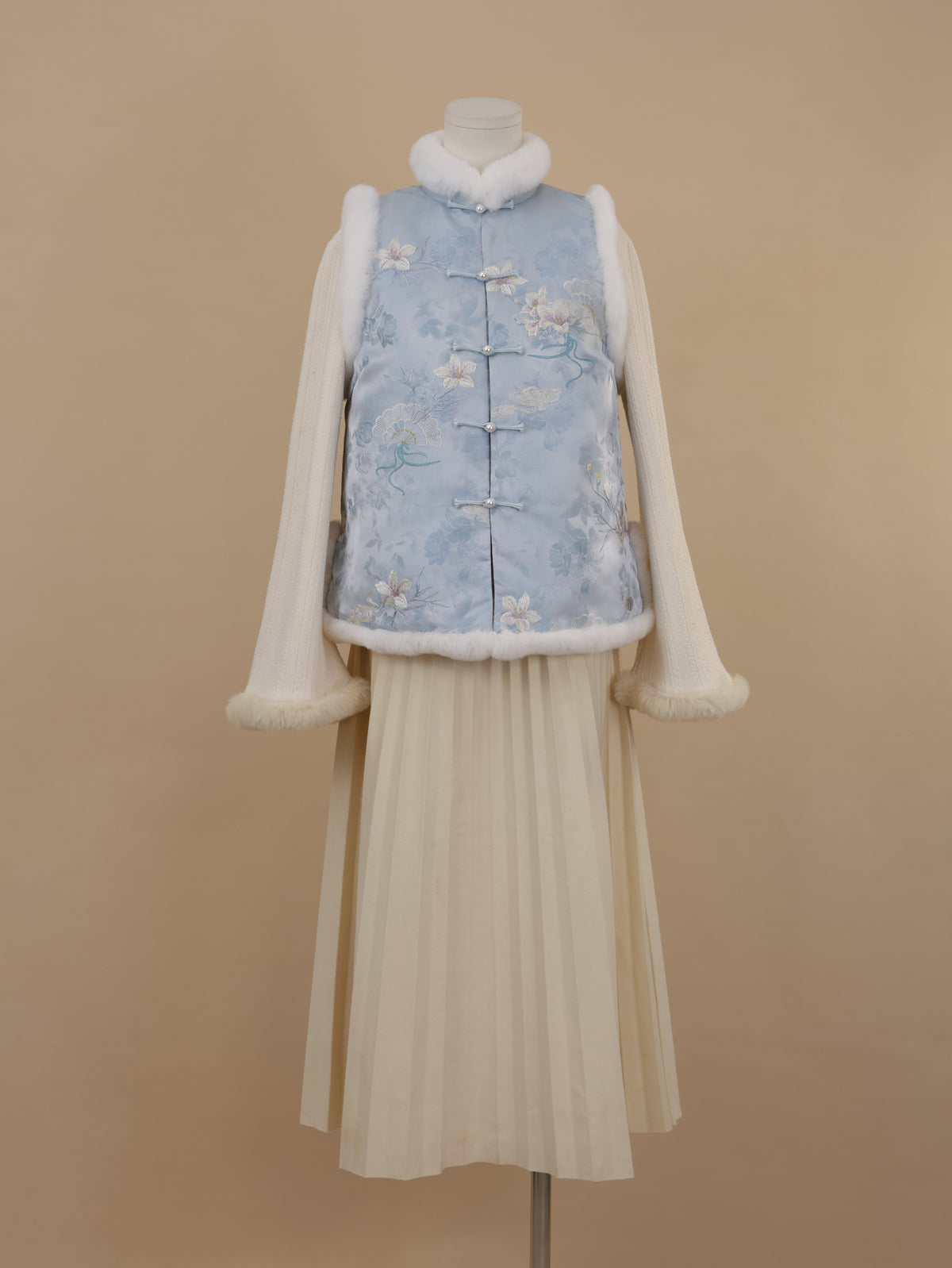 Misty blue embroidered vest with white rabbit fur trim and straight frog-button closure, front view.