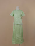 Full front view of pale green silk qipao set with jacquard floral pattern and mid-calf skirt