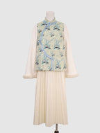 Front view of pastel green panda print vest with wave-front closure and frog button detail