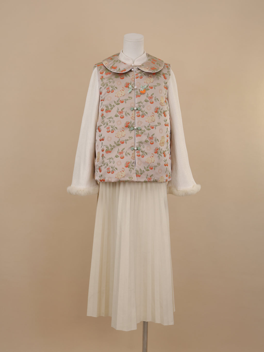 Front view of persimmon and cat print vest with rounded collar and frog buttons
