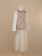 Side view of persimmon and cat print vest with rounded collar and frog button closure