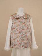 Half front view of beige vest with persimmon and cat print