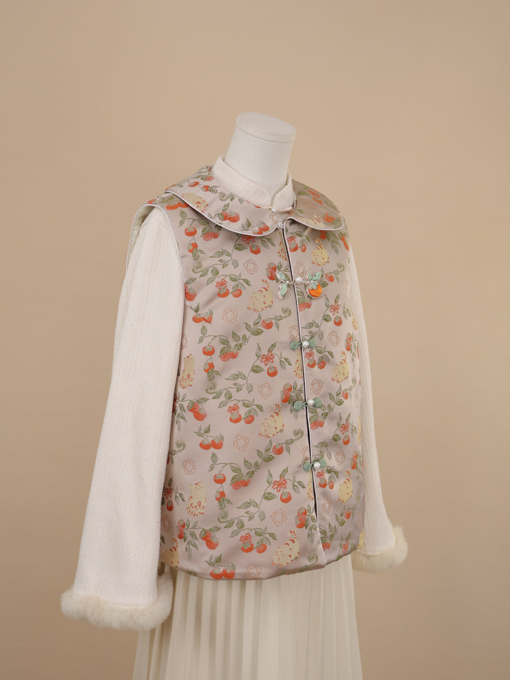 Side view of persimmon cat print vest with rounded collar