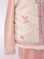 Close-up of hem and rabbit fur trim on pink and white butterfly jacquard vest
