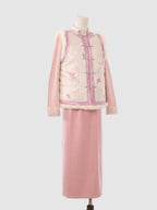 Side view of pink and white butterfly vest showing jacquard texture and fur-trimmed edges