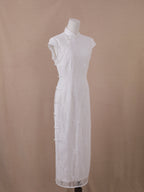 Elegant white lace backless qipao cheongsam, ankle-length with mandarin collar and full side pearl button closure – front view.