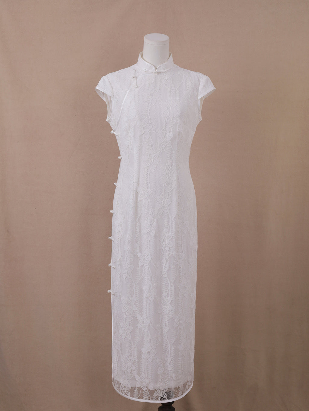 White lace wedding qipao cheongsam, ankle-length with mandarin collar, floral lace, and pearl side closure – front view.