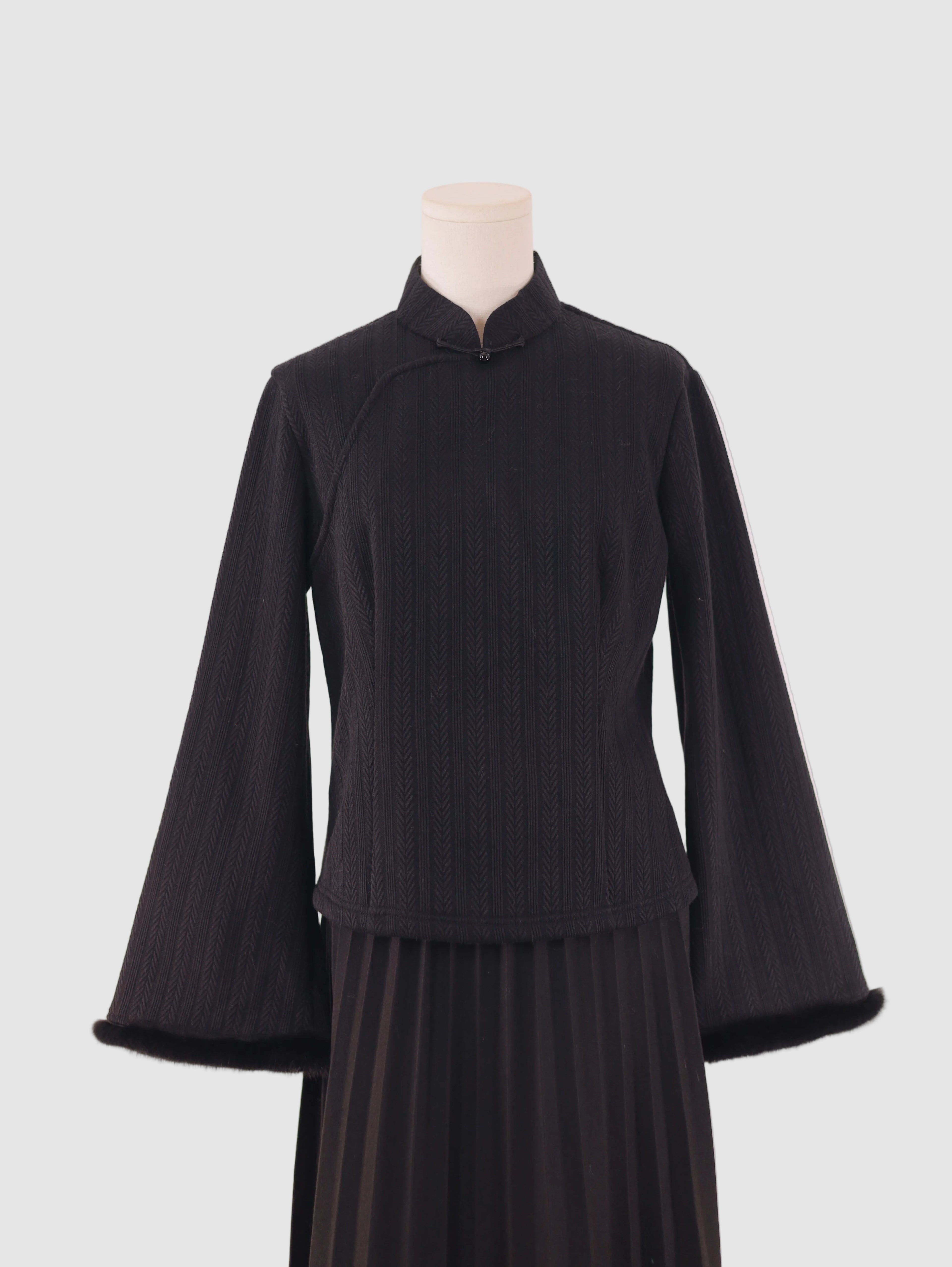 Wide-sleeve knitted fleece-lined base layer top with stand collar and frog button detail, front view