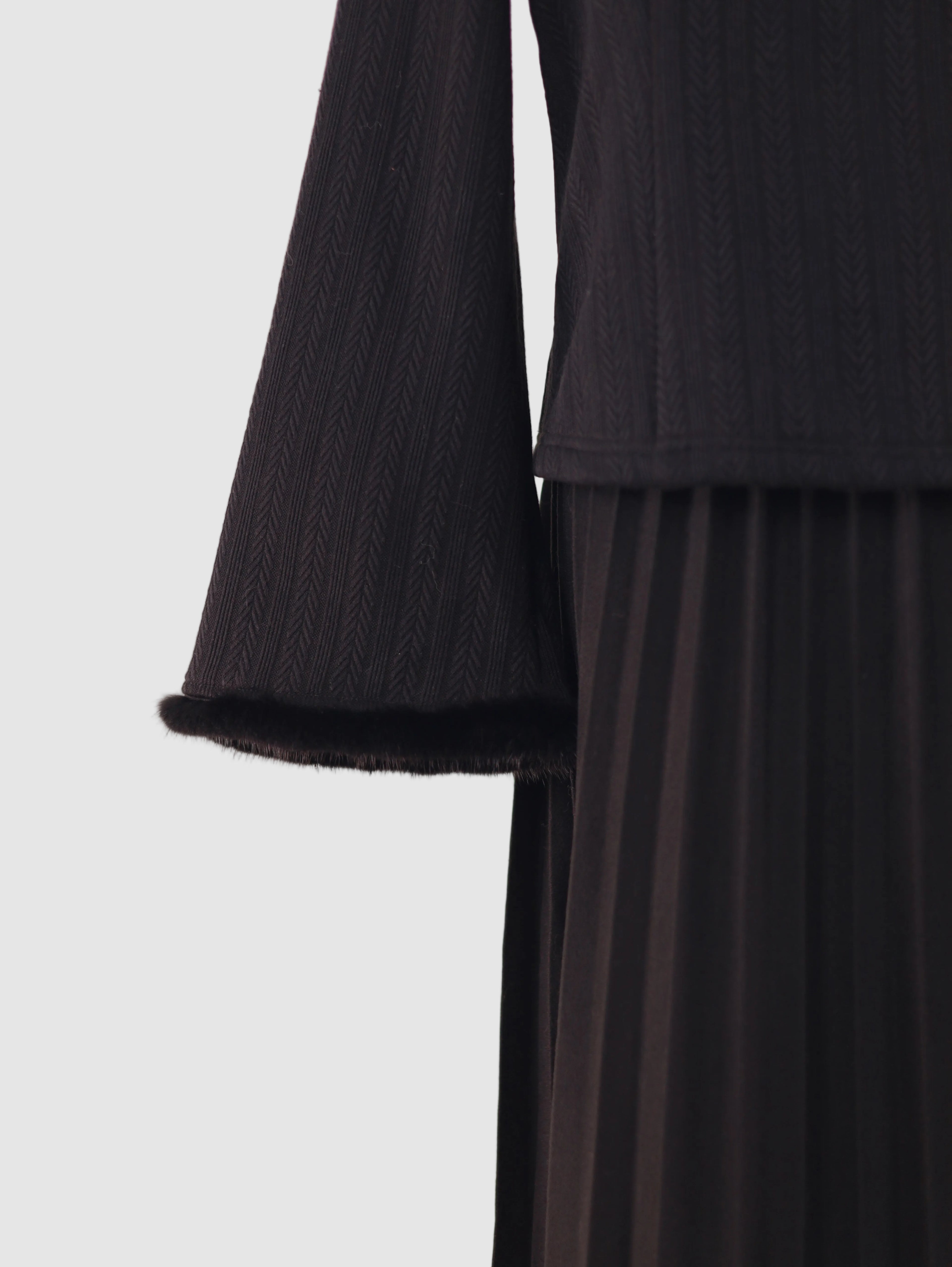 Close-up of hem and sleeve cuffs showing textured knit finish on wide-sleeve fleece-lined base layer top