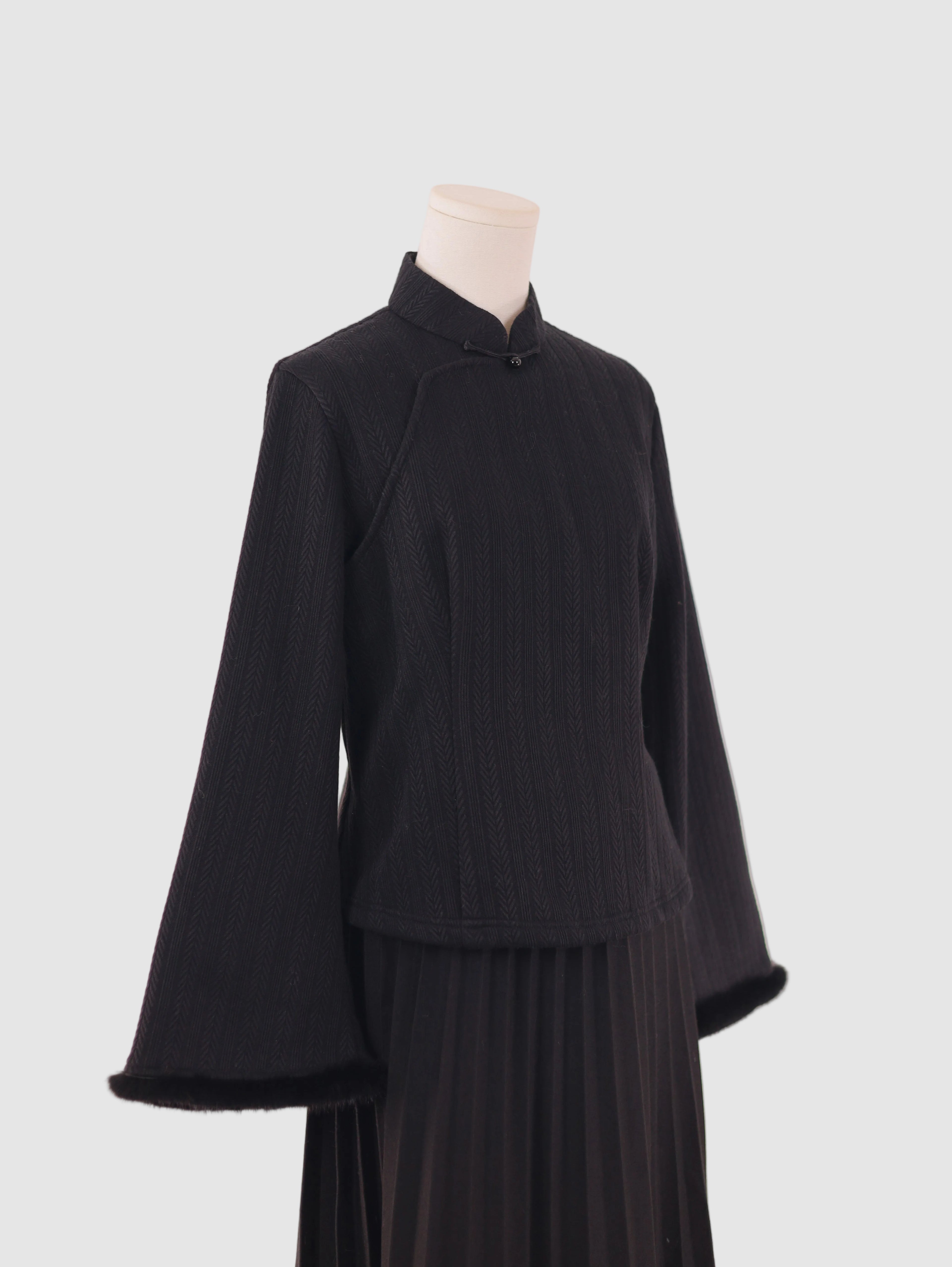 Side view of wide-sleeve knitted fleece-lined base layer top showing relaxed silhouette and sleeve volume